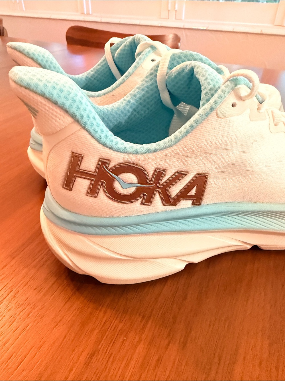 Hoka Clifton 9 Women's Athletic Shoes in White and Light Blue with Bronze Logo